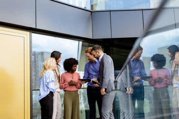 istock Business Professionals Engaging in a Strategy Discussion Outside a Modern Office Building 2147512475