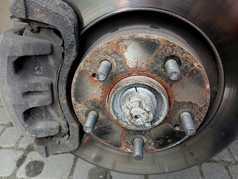 Disc brake pads and brake drums on cars without wheels. Braking system on the front wheel of the car.