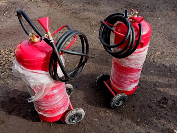 istock Two large 50-liter fire extinguishers stand outside on specially equipped wheels. Powder fire extinguishers for extinguishing fires. Fire extinguishing means. 2147512522