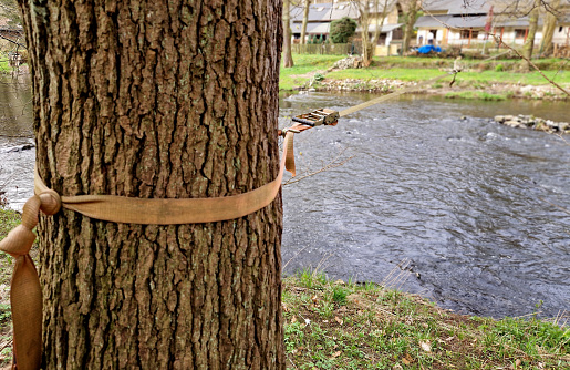 Slackline, or slack for short, is balancing, walking, and jumping on a strap attached between two points, such as trees. Unlike walking on a rope, the slackline strap is not tight