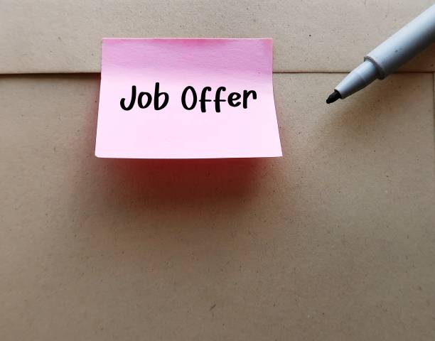 istock Office envelope with stick note written JOB OFFER -  invitation from employer for potential employee to work in a specific position with high salary and benefits 2147513401