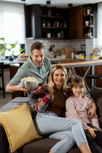istock Family Movie Night: Engrossed in Thrilling Scenes at Home 2147514780