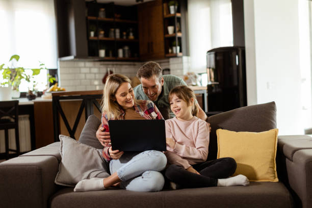 istock Family Bonding Time With Laptop in Cozy Home Setting 2147514781