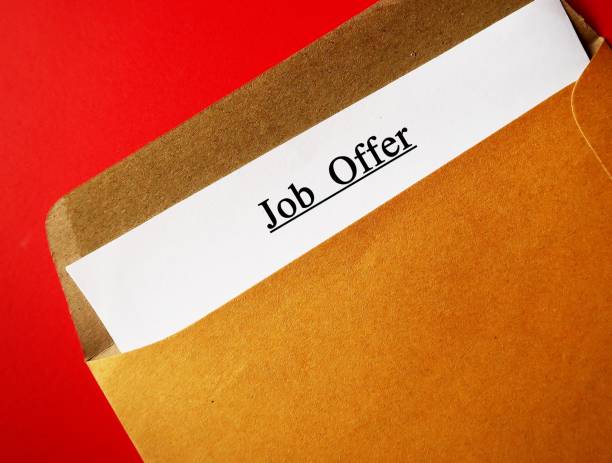 istock Office envelope with text written on ducuments JOB OFFER -  invitation from employer for potential employee to work in a specific position with high salary and benefits 2147514799