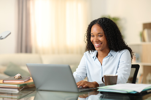 Happy black tele worker working online at home
