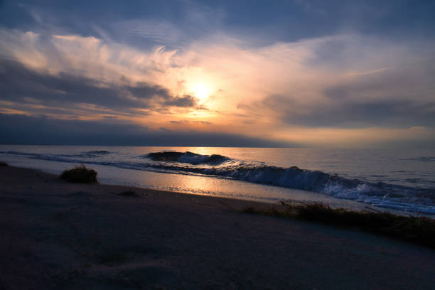 istock Sunset, illuminated sea. Sandy beach in the foreground. Light waves. Baltic Sea 2147517059