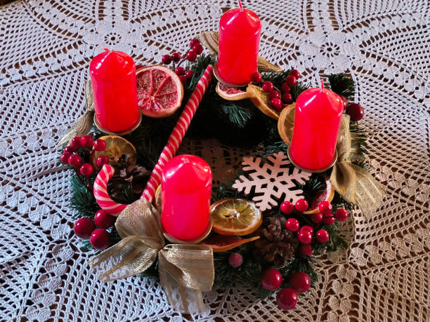 istock advent wreath decorated with red candles at the table 2147517089