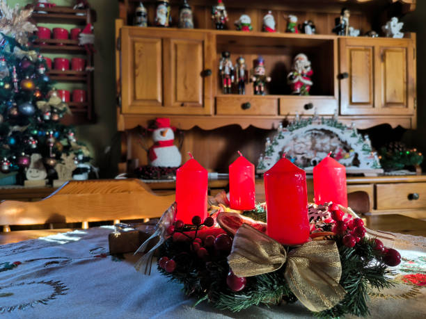istock advent wreath decorated with red candles at the table 2147517820
