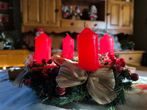 istock advent wreath decorated with red candles at the table 2147517822