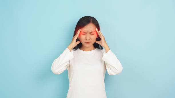 istock Young Woman with Severe Headache on light blue  background 2147517990