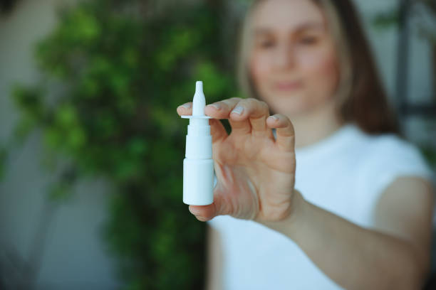 istock Woman is having flu and she is using nasal spray to help herself. 2147518452