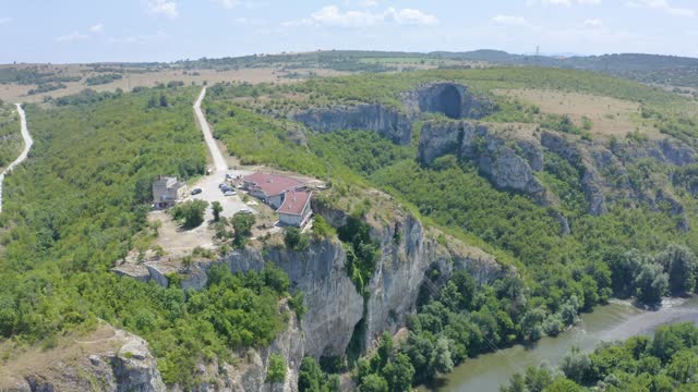 National Cave Home With Prohodna Cave Entrance In The Background In Karlukovo, Bulgaria. - aerial shot