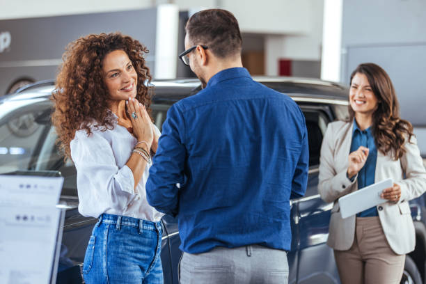 istock Millennial family selecting modern automobile 2147518637