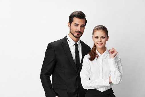 Man and woman smile with teeth business in business attire looking into camera on white isolated background. Stylish business concept paired between employees startup copy place. High quality photo