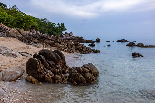 Beautiful rocky beach on a cloudy day at Ko Phangan Island, Thailand.