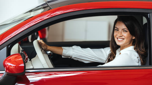 istock Young Woman Embracing Her New Car. 2147519634