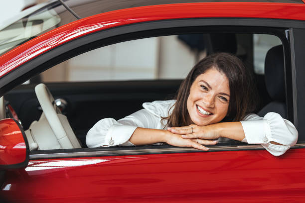 istock Young Woman Embracing Her New Car. 2147519697