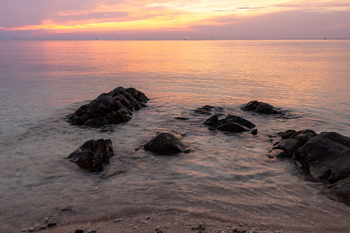Rocks in the shallow sea in sunset at Ko Phangan Island, Thailand.