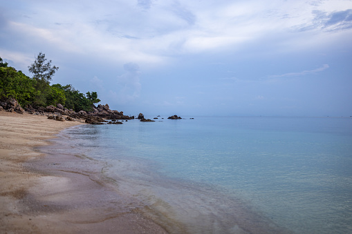 Beautiful rocky beach on a cloudy day at Ko Phangan Island, Thailand.