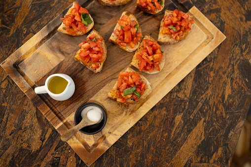 beautifully presented platter of gourmet bruschetta, topped with a vibrant mix of fresh tomatoes and herbs.