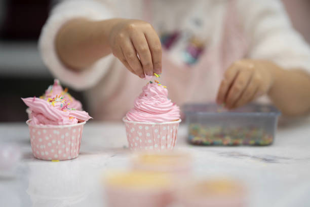 istock Cute little girl at cake making course 2147521450