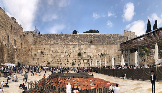 Jerusalem, Israel - Oct 11, 2022: People pray and meditate in front of the The Western Wall during Sukkot Festival.
