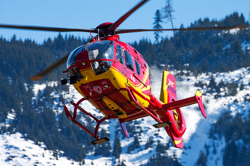 Zell am See, Austria - March 22, 2013: Medical helicopter at airport and airfield. Rotorcraft and medicopter. General aviation industry. Air ambulance transportation. Air transport. Fly and flying.