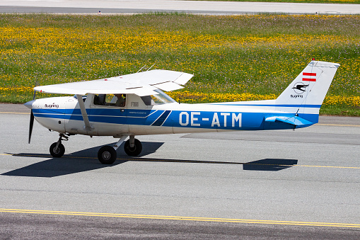 Salzburg, Austria - May 20, 2013: Commercial plane at airport and airfield. Small and sport aircraft. General aviation industry. Vip transport. Civil utility transportation. Fly and flying.