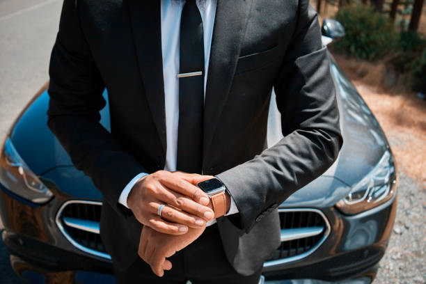 Successful Businessman Checking Time Near Luxury Car