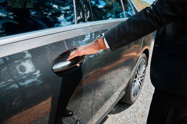 istock Professional Chauffeur Opening Luxury Car Door for Service 2147522695