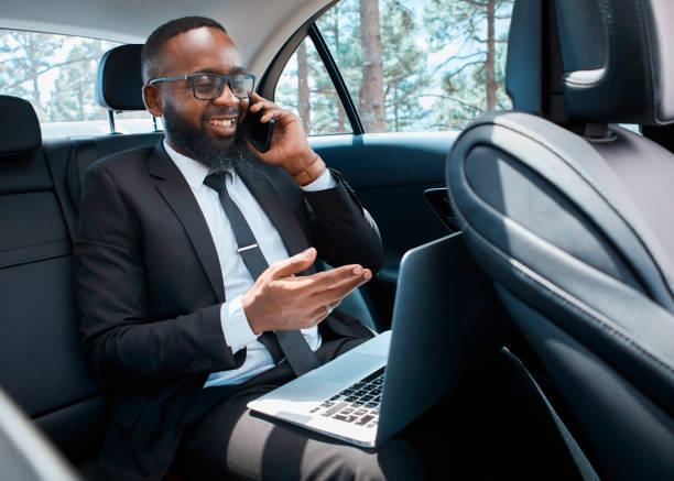 istock Businessman in Suit Working and Talking on Phone in Car 2147522748