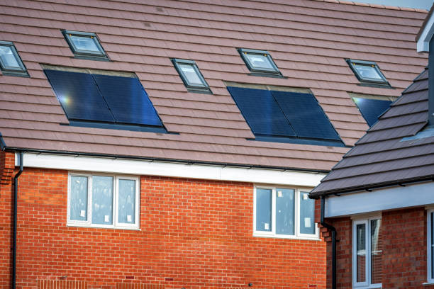 istock Solar energy panel on new built house roof in england uk 2147523098