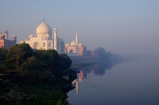 Taj Mahal on the banks of Yamuna river during Sunrise in winter. Agra, Uttar Pradesh, India.