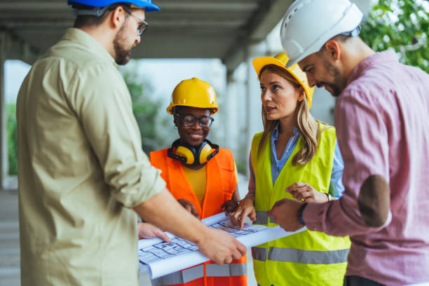 istock Team of construction workers discussing project details with executive supervisor. 2147523953