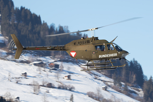 Zell am See, Austria - February 19, 2018: Military helicopter at air base. Air force flight transportation. Aviation and rotorcraft. Transport and airlift. Military industry. Fly and flying.