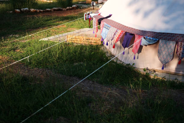 istock Vintage Glamping tent ropes on grass ground in camping area 2147526416