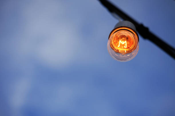 istock Equipped and electrical with light bulbs is shining and hanging in twilight of sunset before night 2147526426
