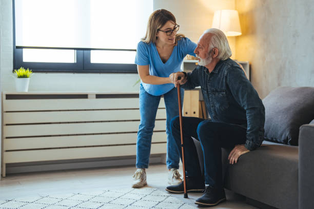istock Young caring nurse helping senior old elderly man grandfather walk . 2147526669