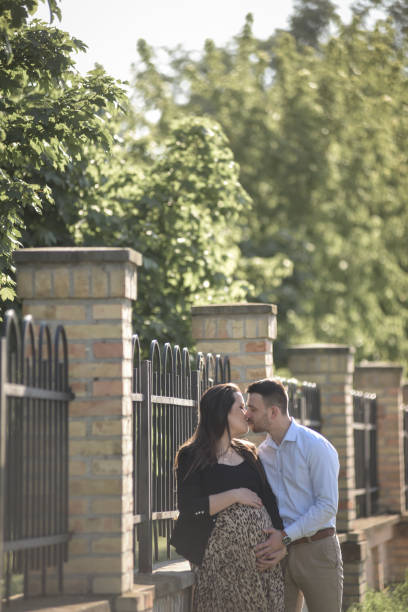 A young expecting couple enjoying together in the nature