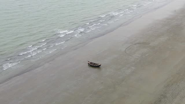 Abandoned traditional Bangladesh fishing boat on the beach Indian Ocean