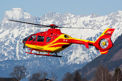 Zell am See, Austria - March 22, 2012: Medical helicopter at airport and airfield. Rotorcraft and medicopter. General aviation industry. Air ambulance transportation. Air transport. Fly and flying.