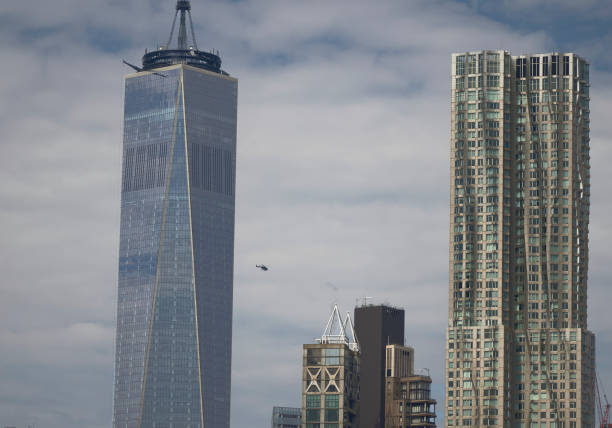 New York (United States), March 22, 2024.  A commercial plane flies over Manhattan, just above the One World Trade Center tower, remembering the events of September 11