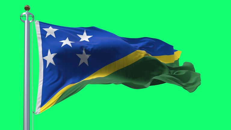 Detail of the national flag of Solomon Islands waving isolated on green background