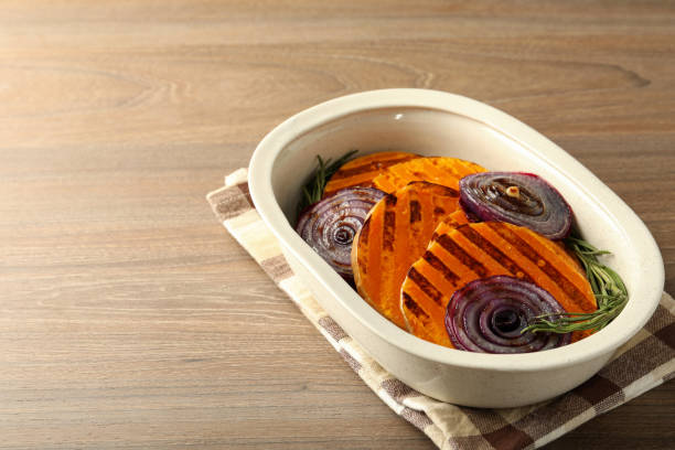 istock Baking tray with baked pumpkin on wooden background 2147530084