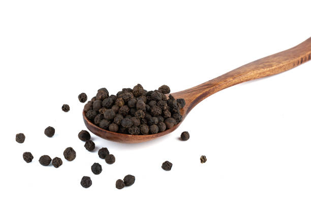 istock Black pepper peas in wooden spoon on white background. 2147530608