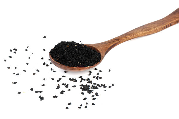 istock Black sesame seeds on wooden spoon on white background. 2147530625