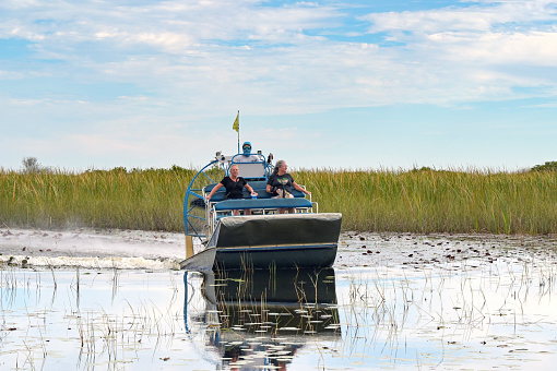 Everglades National Park, Florida, USA - 4 December 2023: Tourists on an airboat ride across the water in the State's national park