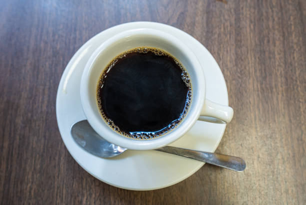 istock Black americano coffee on wooden table 2147532913