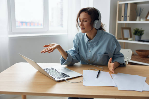 istock Irritated businesswoman actively gesticulating holds meeting using computer app, distant communication with subordinates about terrible results of month, tries explain employees tasks to improve work 2147533712
