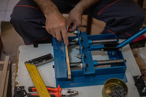 Senior man prepares honeycomb frames for beehives